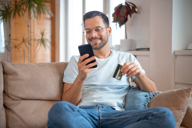 istock Man using his credit card to shop online 1451909448