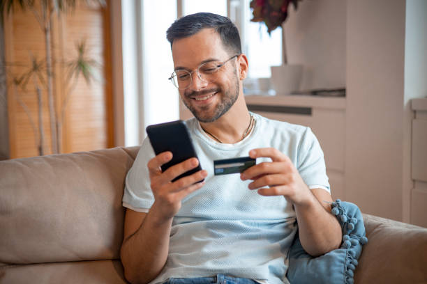 istock Man using his credit card to shop online 1451909455