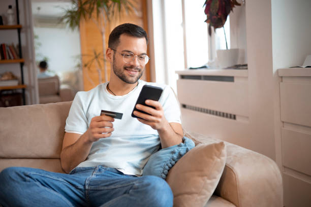 istock Man using his credit card to shop online 1451909514
