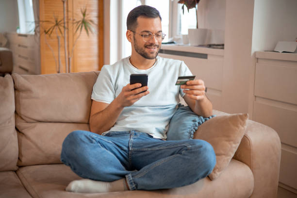 istock Man using his credit card to shop online 1451909525