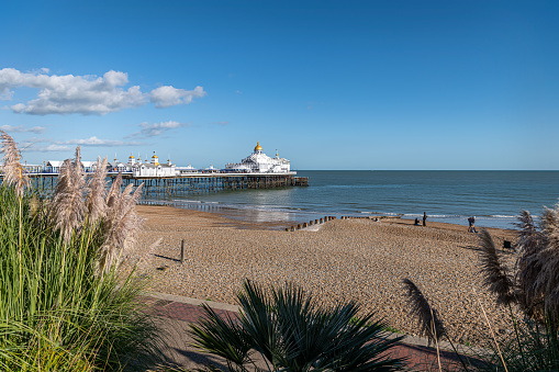 Eastbourne Pier and Beach with a clear blue sky, Eastbourne, England