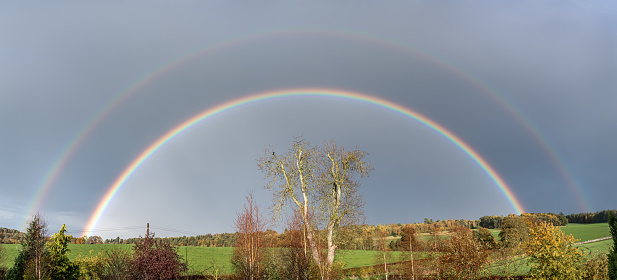 Double rainbow arcing over farmland and fields. Herefordshire, UK