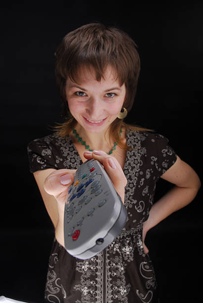 Woman and remote control stock photo