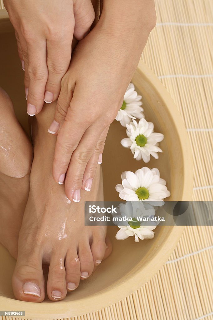 relaxing moments beautiful legs and hands with perfect french pedicure Adult Stock Photo