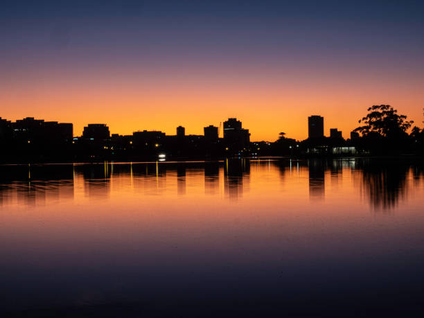 Urban skyline reflections Buildings reflected in Albert Park Lake at dawn albert park photos stock pictures, royalty-free photos & images