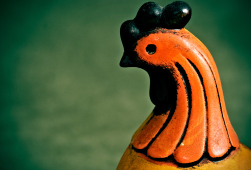 Orange face of a Folk art Chicken