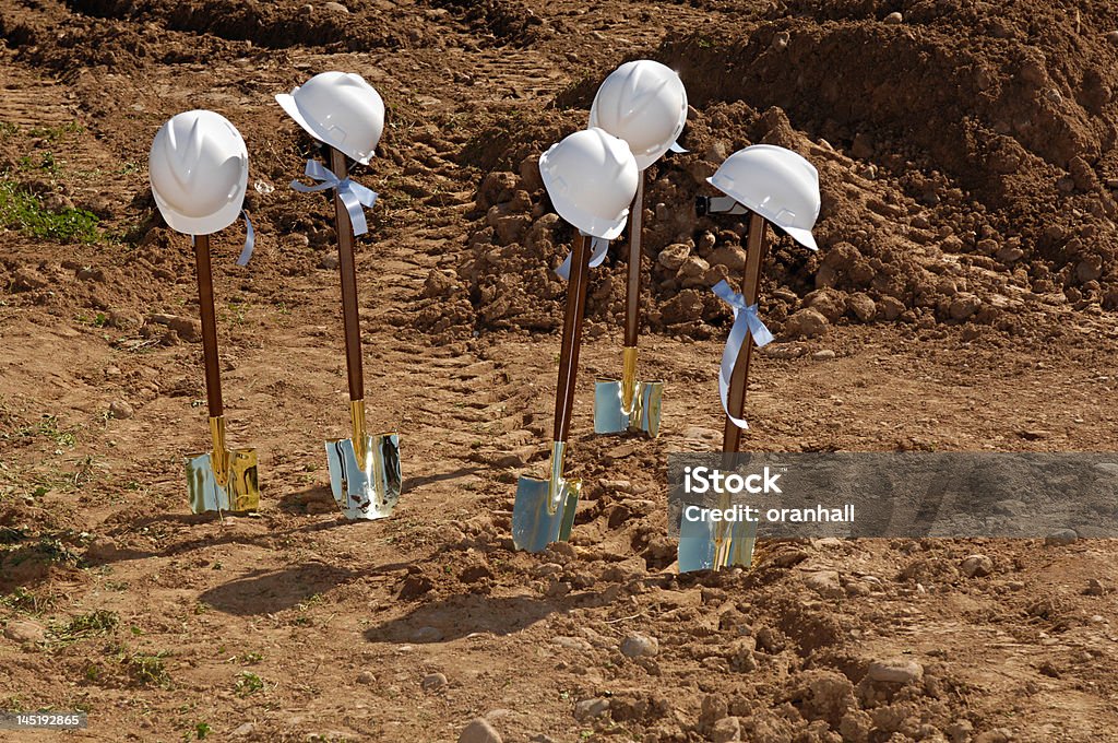 Groundbreaking Shovels and hardhats at a groundbreaking Innovation Stock Photo