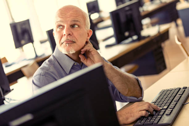 istock Man at computer listens to colleague's opinion 1451931209