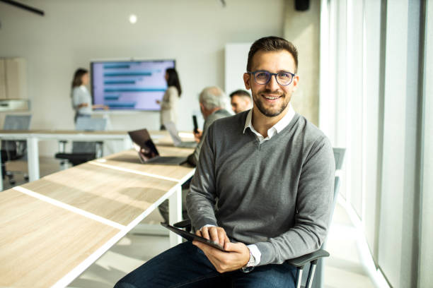 istock Confident young man businessman working inside modern office on a digital tablet 1451935312