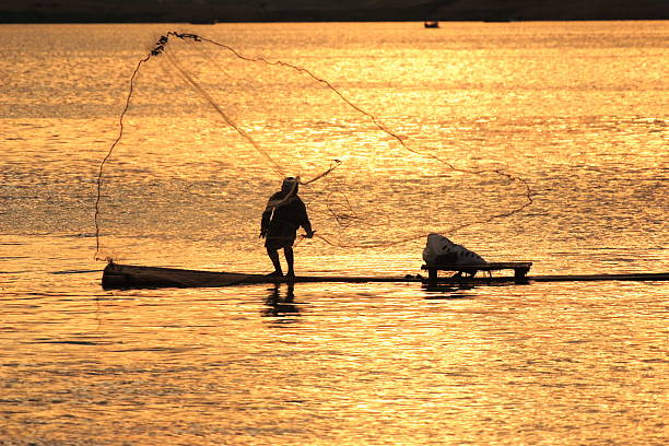 istock Fisherman with golden background 145193625