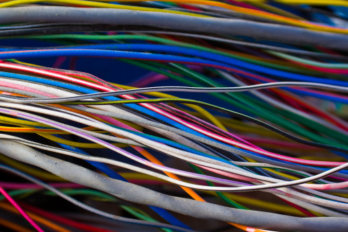 A jumble of multi colored wires from a car
