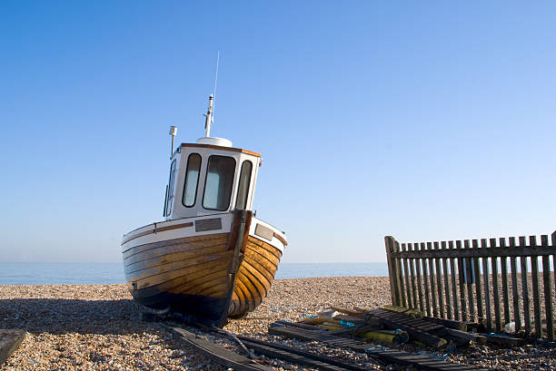 istock Wooden Boat on Pebble Beach 145194160
