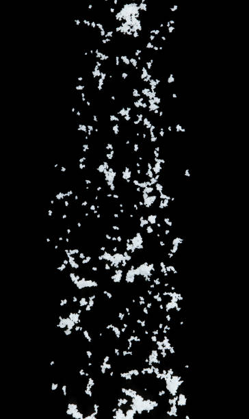 Salt flying explosion, crystal white grain salts explode abstract cloud fly. Beautiful complete seed salt splash in air, food object design. Selective focus freeze shot black background isolated