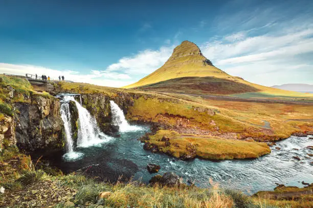 landscape view of Kirkjufellsfoss In the daytime, blue sky and beautiful clouds. The waterfall is famous and a popular tourist spot in Iceland. High quality photo