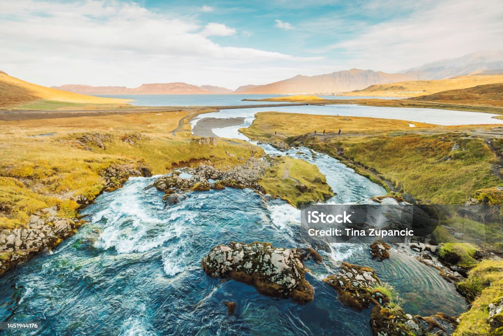 River running down to the sea, somwhere in Iceland River stream running down tho the sea on a sunny autumn day in Iceland. Architecture Stock Photo