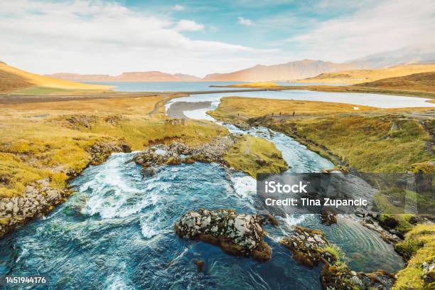 River Running Down To The Sea Somwhere In Iceland Stock Photo - Download Image Now - Architecture, Atlantic Ocean, Bay of Water