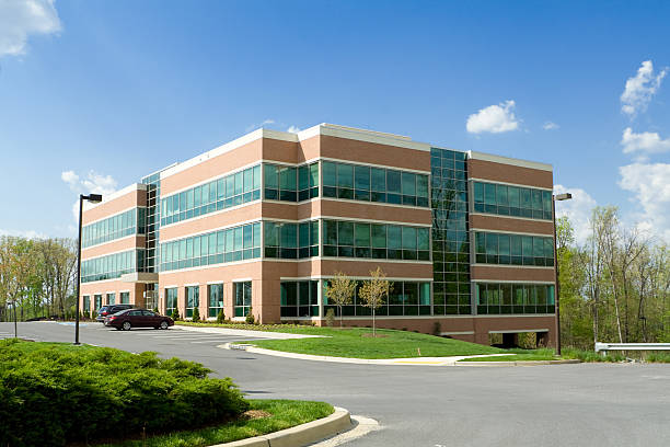Modern Cube Shaped Office Building, Parking Lot, Suburban Maryland, USA New office building in suburban Maryland, United States.  Parking lot in front of the building with several cars.  - See lightbox for more office building exterior photos stock pictures, royalty-free photos & images