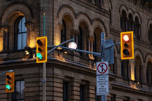 Traffic lights against historical building in downtown Ottawa, Canada at night.