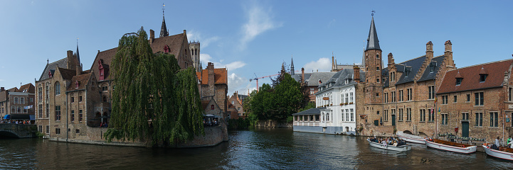 Panoramic cityscape of houses with canal of water at Rozenhoedkaai, Bruges, Belgium
