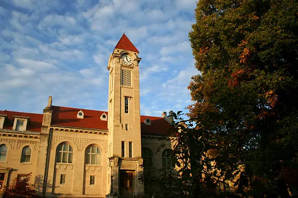 Photo of Clock tower against a slightly cloudy blue sky