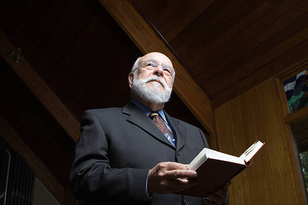 istock Senior man standing and singing a hymn in church 145196165