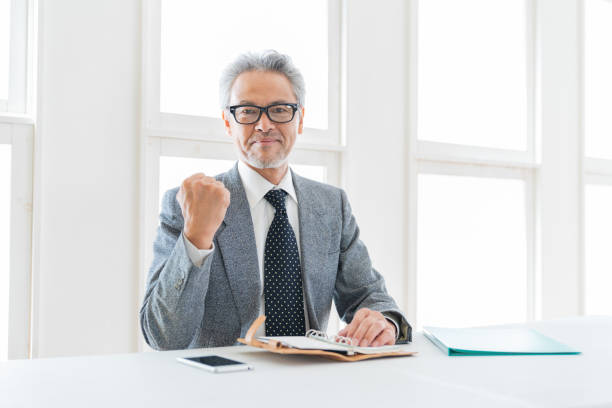 asian businessman who fills out a schedule book stock photo