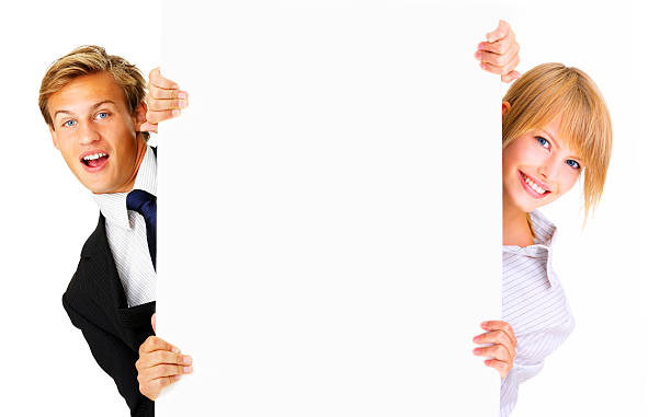 close -up of 若いカップル、ブランクサインボードを保持 - advertisement advertise businesswoman peeking ストックフォトと画像