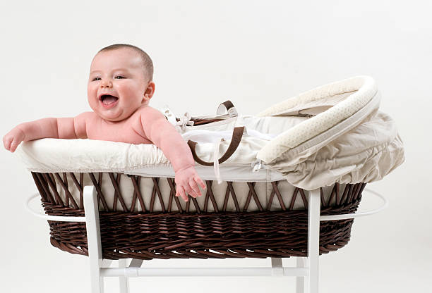 Happy Baby Newborn Baby and a Moses Basket moses basket stock pictures, royalty-free photos & images