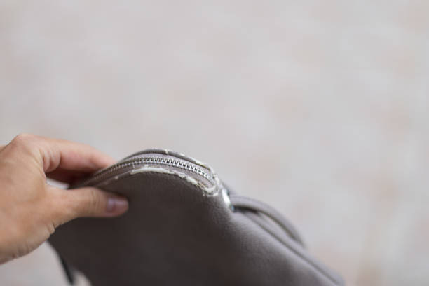 istock Woman's hand holding grey shabby bag. 1451977423