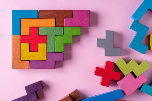 istock Colorful wooden blocks folding on pink background 1451977976