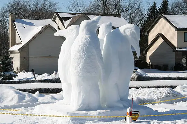 Snow sculpture of a group of penguins.