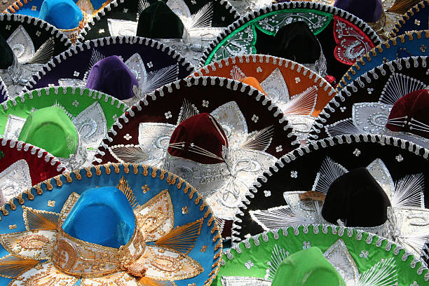 young tourist enjoying the national holidays celebrated in Mexico wearing traditional clothing such as the charro hat with the colors of the flag