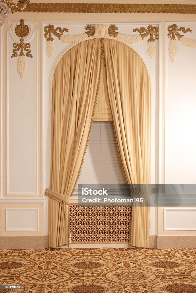 Beautiful Window Treatment Large Gothic window with gold curtains and intricate trim work. Arch - Architectural Feature Stock Photo