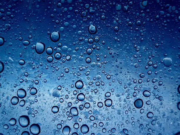 water bubbles seen in transparency through a blue background. This picture is great for advertising as well as background. The water bubbles can can also be interpreted as cells of other nature.