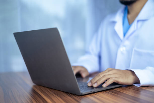 istock People using computer Side view of male hands typing on laptop keyboard 1451985935