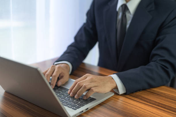 istock People using computer Side view of male hands typing on laptop keyboard 1451985937