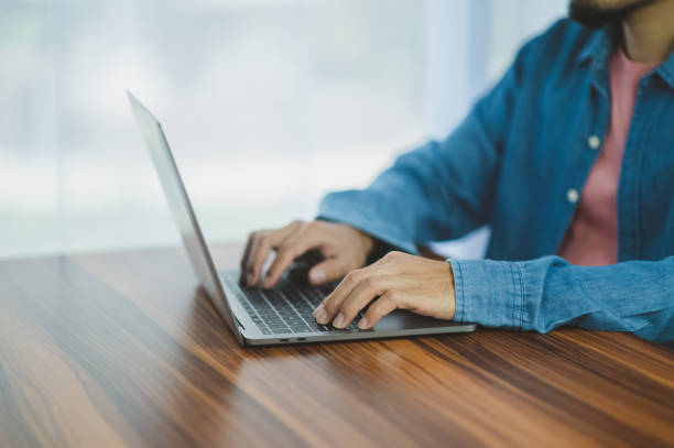 istock People using computer Side view of male hands typing on laptop keyboard 1451985966