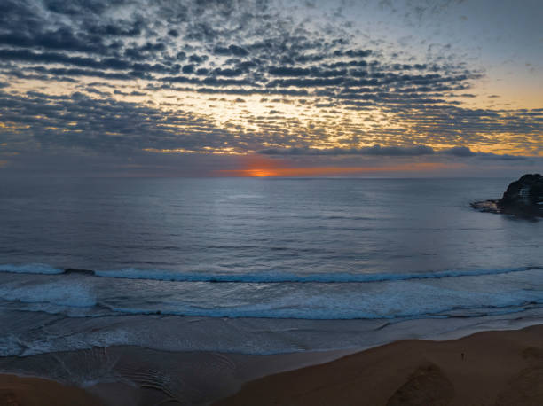 istock Beautiful sunrise with clouds over the ocean 1451989452