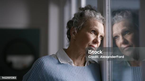 Elderly Woman Window Reflection And Depression While Thinking Wonder And Mental Health In Home Senior Lady Retirement Anxiety And Sad In House With Stress Mirror And Depressed In San Francisco Stock Photo - Download Image Now