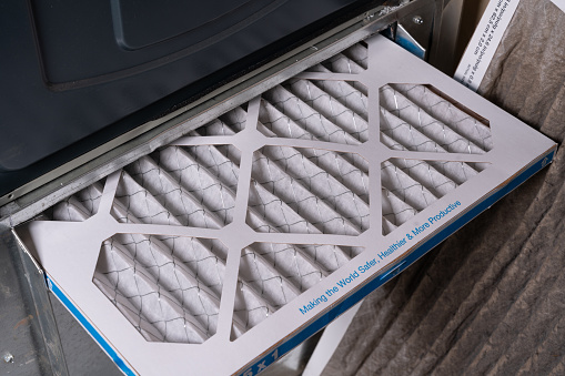 Replacing dirty furnace filter in home