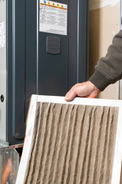istock Man replacing dirty furnace filter in home 1452014619