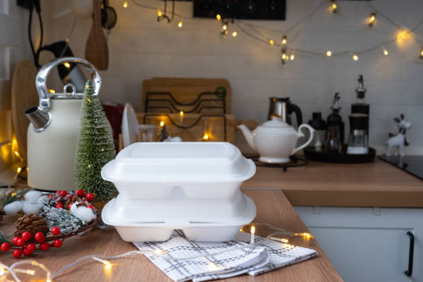 istock Food delivery service containers on table white scandi festive kitchen in christmas decor. Eve New year, saving time, too lazy to cook, hot order, disposable plastic box in fairy light. mock up 1452014641