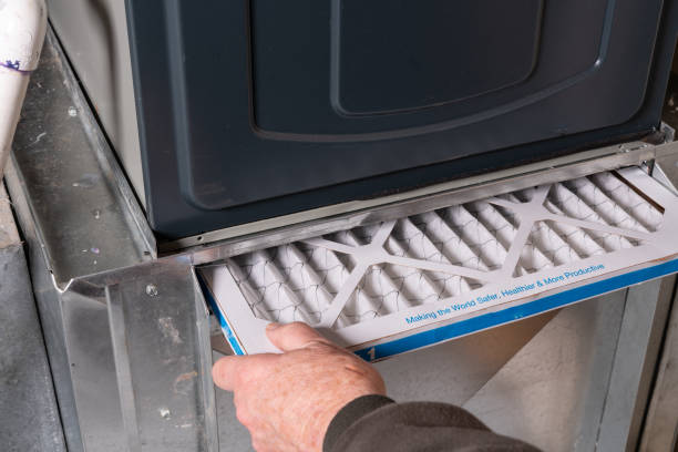 istock Man replacing dirty furnace filter in home 1452014652