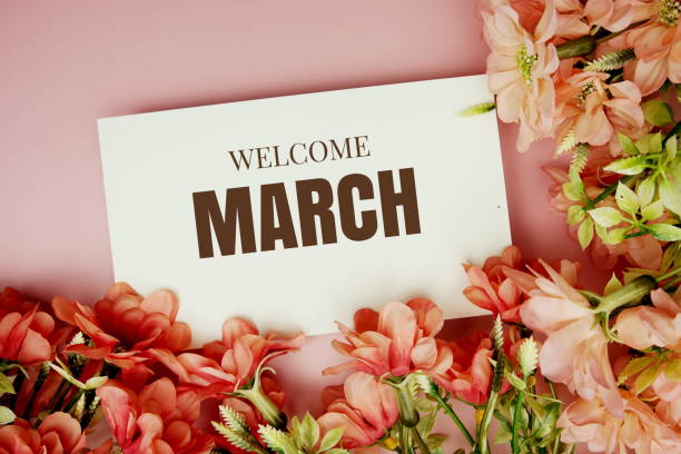 istock Welcome March typography text with flowers frame on pink background 1452016207