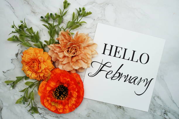 istock Hello February text with orange flower bouquet on marble background 1452016280