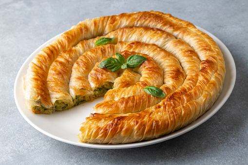 Traditional Turkish pastry with spinach. (Turkish Name: Ispanakli Kol Boregi, Bosnak boregi). Handmade pastry with spinach filling.