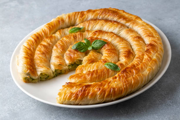 Traditional Turkish pastry with spinach. (Turkish Name: Ispanakli Kol Boregi, Bosnak boregi). Handmade pastry with spinach filling. Traditional Turkish pastry with spinach. (Turkish Name: Ispanakli Kol Boregi, Bosnak boregi). Handmade pastry with spinach filling. filo pastry stock pictures, royalty-free photos & images