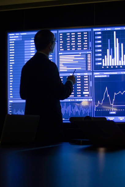 Back view of investor using charts and diagrams