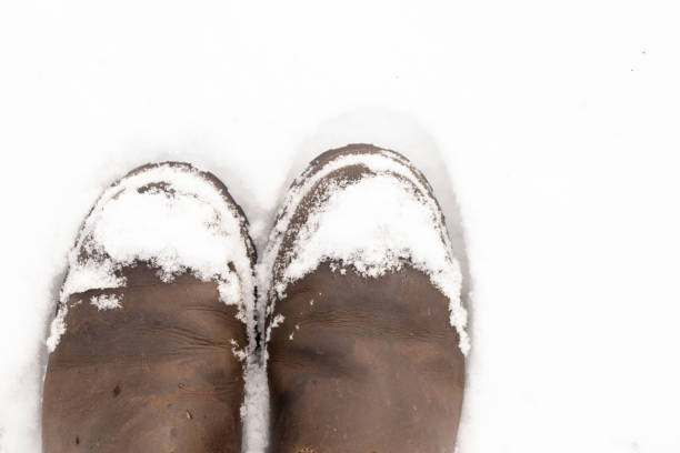 istock women's boots in the snow top view 1452024131