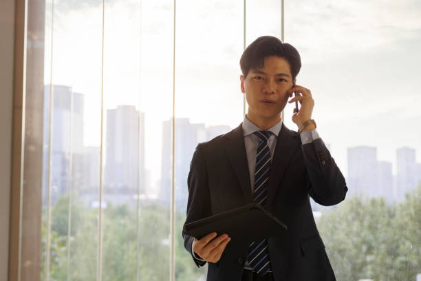 istock Young Asian businessmen call in the office 1452024310